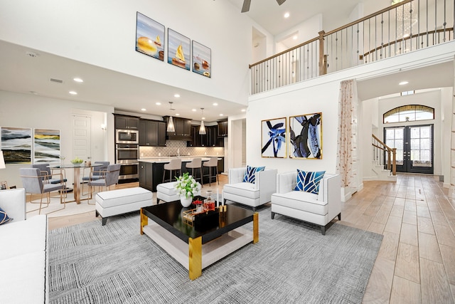 28946 Parker Ridge Dr, Katy, TX 77494 - living area featuring a high ceiling, recessed lighting, ceiling fan, light wood finished floors, and stairs