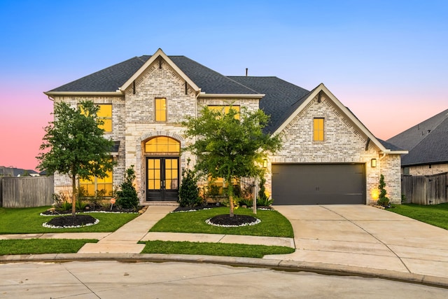 28946 Parker Ridge Dr, Katy, TX 77494 - french country home with french doors, brick siding, concrete driveway, and a shingled roof