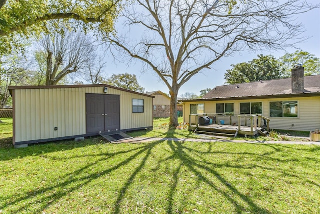 12938 Dermott Dr, Houston, TX 77065 - view of green lawn with a wooden deck, an outdoor structure, and a storage unit