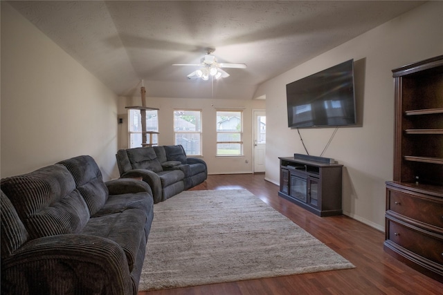 living room featuring ceiling fan, vaulted ceiling, wood finished floors, and baseboards
