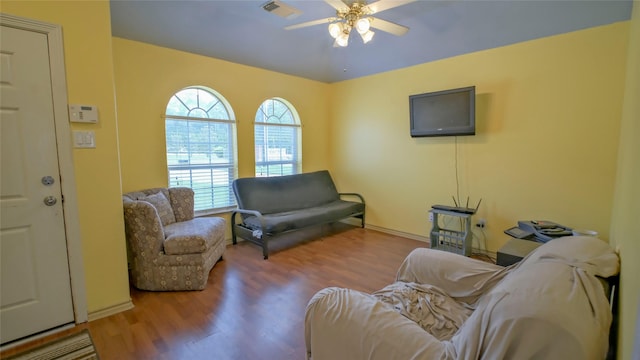 living room with a ceiling fan and wood finished floors