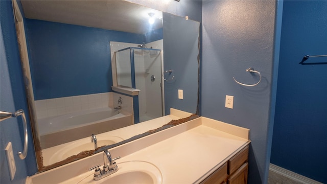 bathroom featuring a shower stall, vanity, and a bath