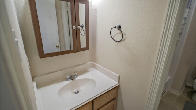 full bathroom featuring vanity, curtained shower, toilet, and tile patterned flooring