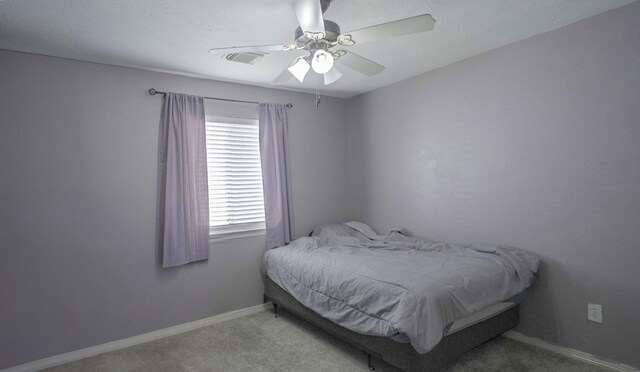 bedroom featuring carpet floors, a ceiling fan, and baseboards