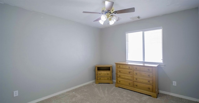 unfurnished bedroom with light carpet, baseboards, and a ceiling fan