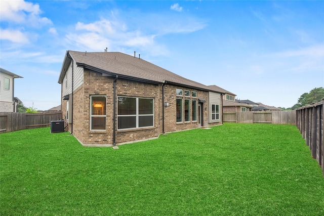 2411 Jitterbug Ln, Katy, TX 77493 - rear view of property featuring brick siding, central air condition unit, and a shingled roof