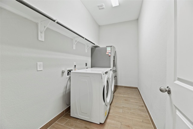 2411 Jitterbug Ln, Katy, TX 77493 - washroom with washing machine and clothes dryer, baseboards, and wood finish floors