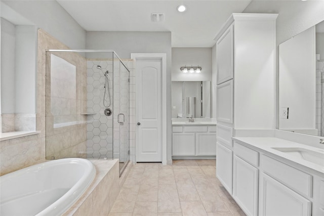 2411 Jitterbug Ln, Katy, TX 77493 - bathroom featuring a shower stall, a bath, two vanities, and recessed lighting