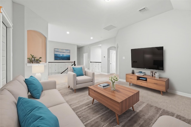 2411 Jitterbug Ln, Katy, TX 77493 - living area with arched walkways, light colored carpet, baseboards, and recessed lighting