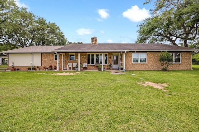 6825 Highland Rd, Santa Fe, TX 77517 - single story home with a chimney, a front yard, and brick siding