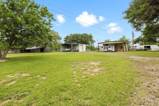 6825 Highland Rd, Santa Fe, TX 77517 - view of yard featuring a detached carport and an outbuilding