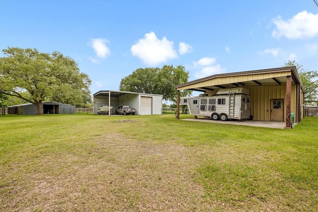 6825 Highland Rd, Santa Fe, TX 77517 - view of green lawn featuring a detached garage, a pole building, and an outbuilding