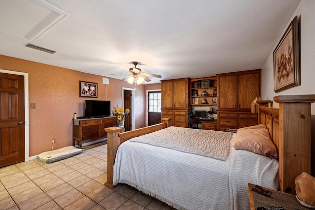 6825 Highland Rd, Santa Fe, TX 77517 - bedroom with light tile patterned flooring, a textured wall, ceiling fan, and baseboards