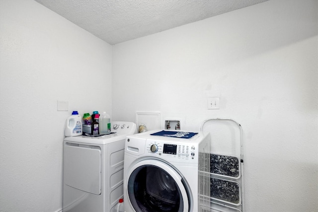 6825 Highland Rd, Santa Fe, TX 77517 - clothes washing area featuring separate washer and dryer and a textured ceiling