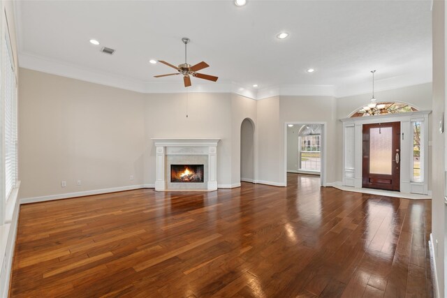 unfurnished living room with ceiling fan, recessed lighting, hardwood / wood-style floors, a fireplace with flush hearth, and crown molding