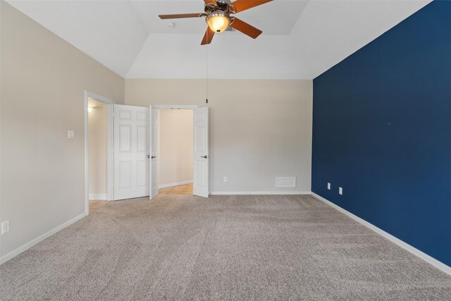 unfurnished room with a ceiling fan, light colored carpet, baseboards, and high vaulted ceiling
