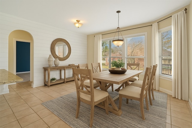 dining space with light tile patterned flooring and baseboards