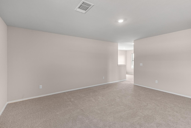 unfurnished room with carpet floors, baseboards, and recessed lighting
