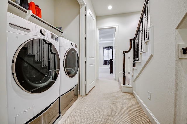 laundry area with washing machine and dryer, light colored carpet, recessed lighting, and baseboards