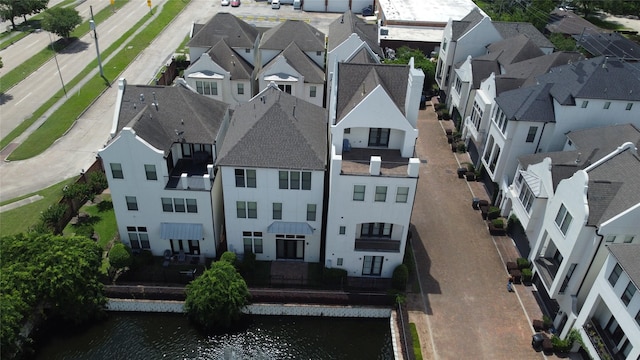aerial view of residential area featuring a large body of water