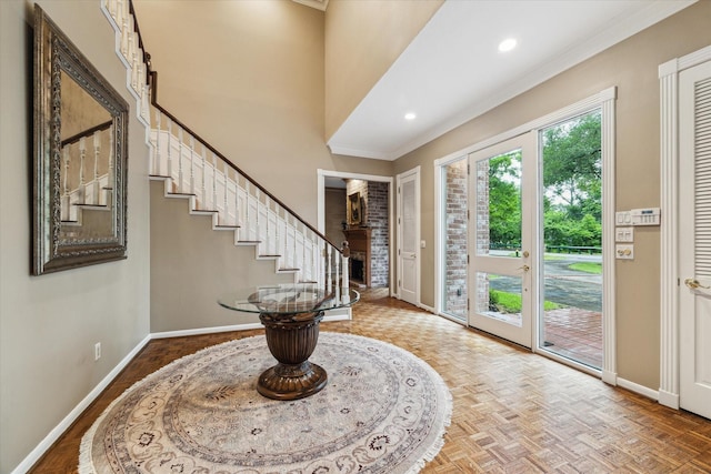 entryway with baseboards, ornamental molding, stairs, and recessed lighting