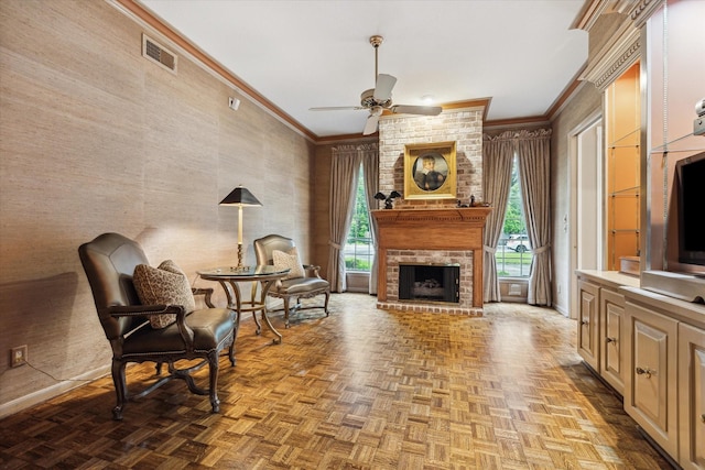 sitting room with a ceiling fan, crown molding, a fireplace, and baseboards
