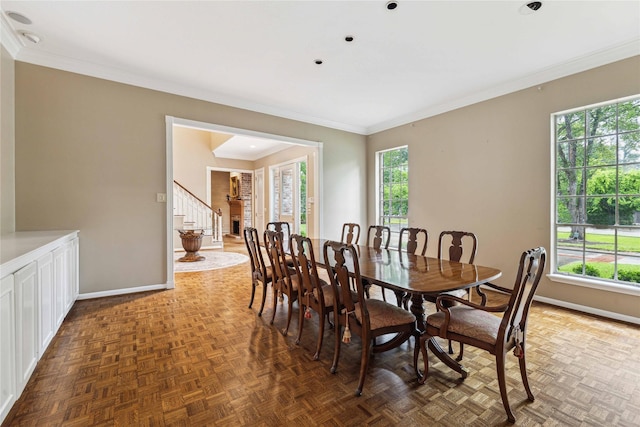 dining space featuring baseboards, ornamental molding, and stairs