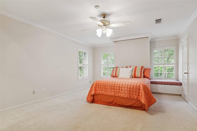 carpeted bedroom with crown molding, baseboards, and a ceiling fan