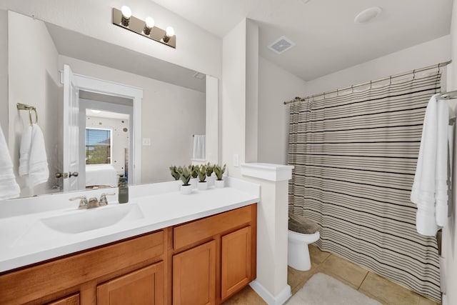 full bathroom featuring ensuite bathroom, vanity, tile patterned floors, and toilet
