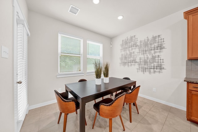 dining space with recessed lighting, light tile patterned flooring, and baseboards