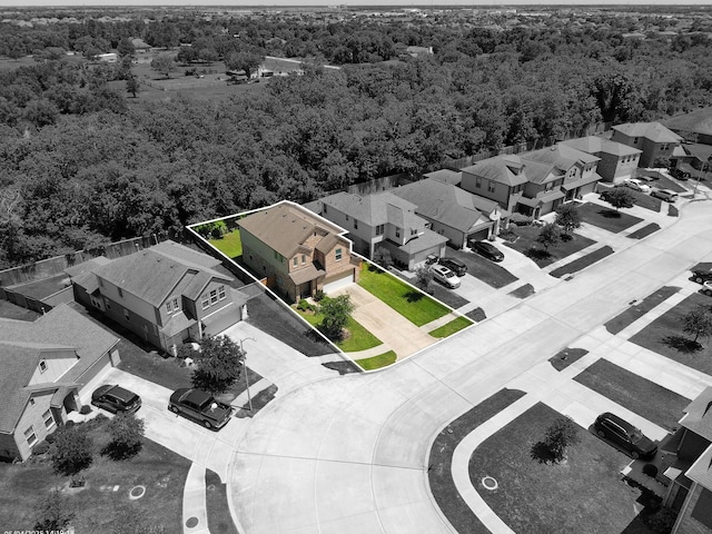 aerial view of residential area with a forest and property boundaries highlighted