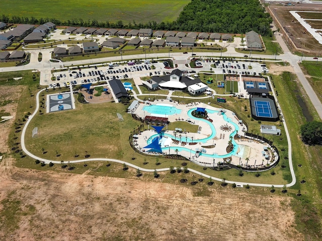 aerial view of property's location with a pool area and nearby suburban area