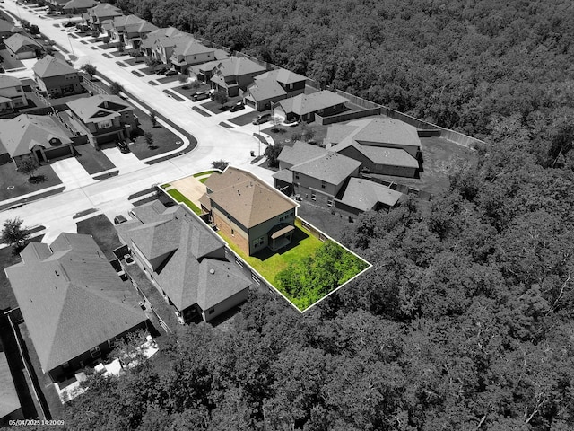 aerial perspective of suburban area featuring a forest and property boundaries highlighted