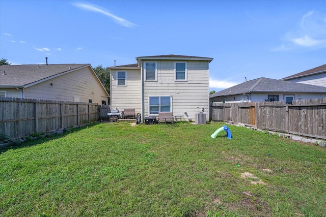 rear view of house featuring central AC unit