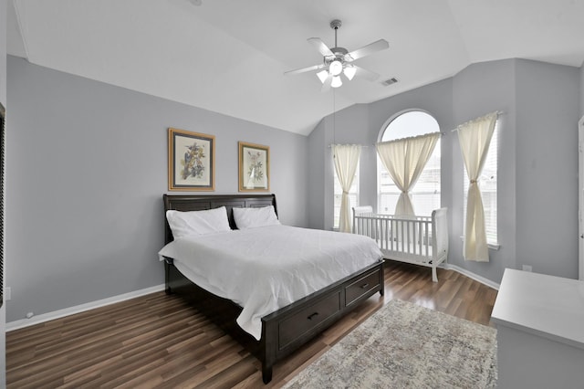 bedroom with lofted ceiling, dark wood finished floors, baseboards, and ceiling fan