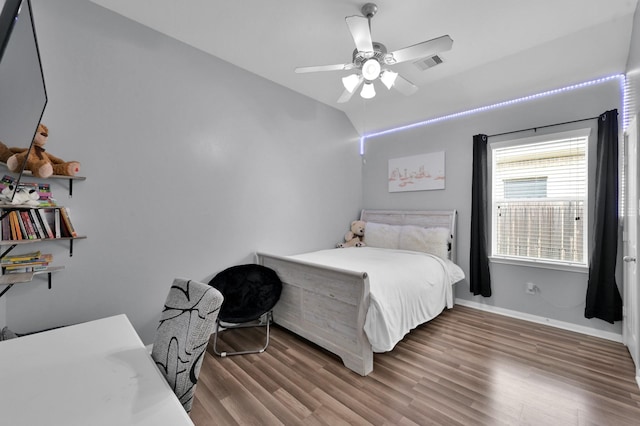 bedroom featuring wood finished floors, baseboards, and ceiling fan