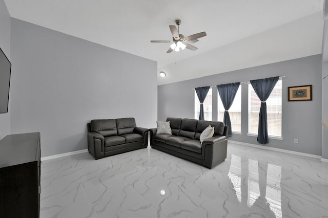 living area with a ceiling fan, light marble finish floors, and baseboards