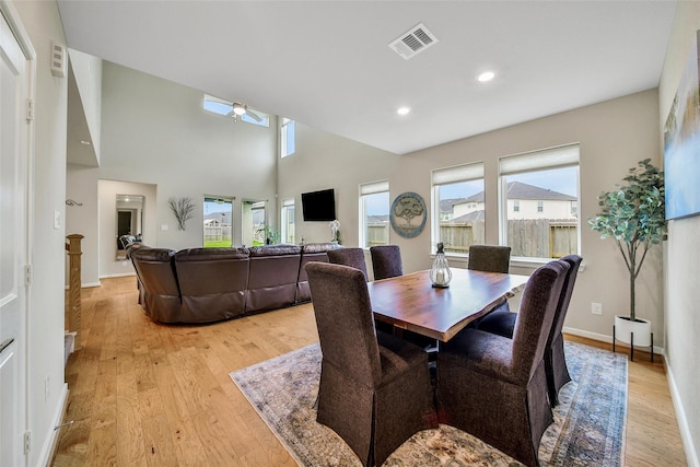 22110 Sam Raburn Dr, Tomball, TX 77375 - dining space with light wood finished floors, ceiling fan, recessed lighting, baseboards, and a towering ceiling
