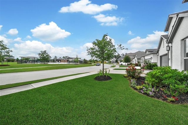 22110 Sam Raburn Dr, Tomball, TX 77375 - view of grassy yard featuring a residential view and a garage