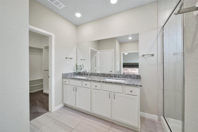 22110 Sam Raburn Dr, Tomball, TX 77375 - full bath featuring a stall shower, double vanity, a spacious closet, and baseboards