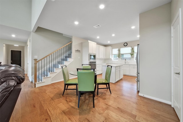 22110 Sam Raburn Dr, Tomball, TX 77375 - dining area with stairway, light wood-style floors, recessed lighting, and baseboards