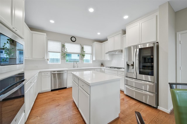 22110 Sam Raburn Dr, Tomball, TX 77375 - kitchen with appliances with stainless steel finishes, a sink, backsplash, light countertops, and white cabinetry