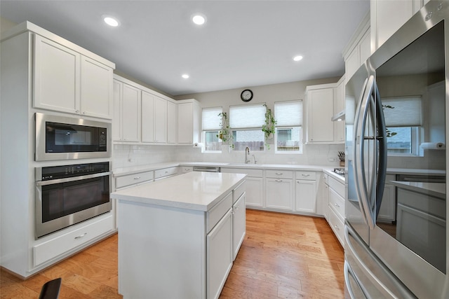 22110 Sam Raburn Dr, Tomball, TX 77375 - kitchen with stainless steel appliances, a sink, decorative backsplash, light countertops, and recessed lighting