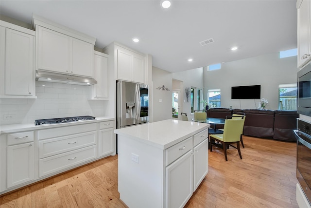 22110 Sam Raburn Dr, Tomball, TX 77375 - kitchen with appliances with stainless steel finishes, open floor plan, under cabinet range hood, white cabinetry, and recessed lighting