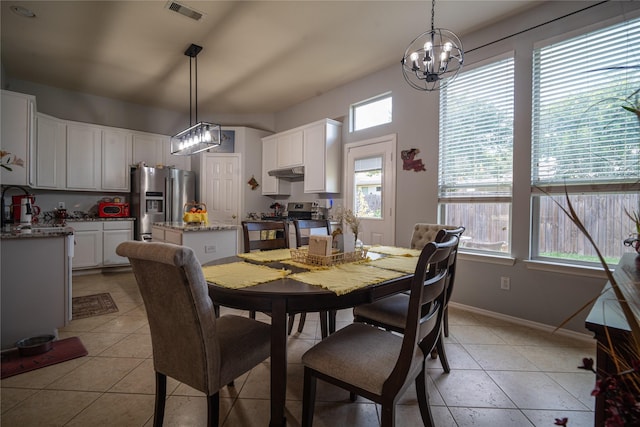32102 Annice Ln, Pinehurst, TX 77362 - dining room featuring a chandelier, baseboards, and light tile patterned flooring