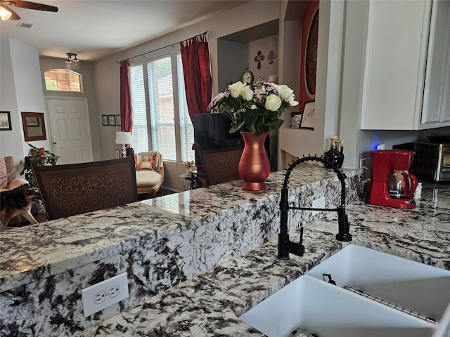 32102 Annice Ln, Pinehurst, TX 77362 - kitchen featuring a sink, white cabinets, and ceiling fan