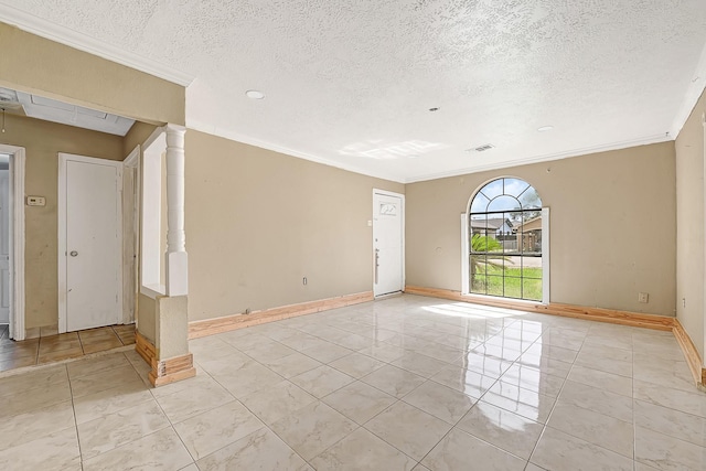unfurnished room with crown molding, a textured ceiling, light tile patterned floors, and baseboards
