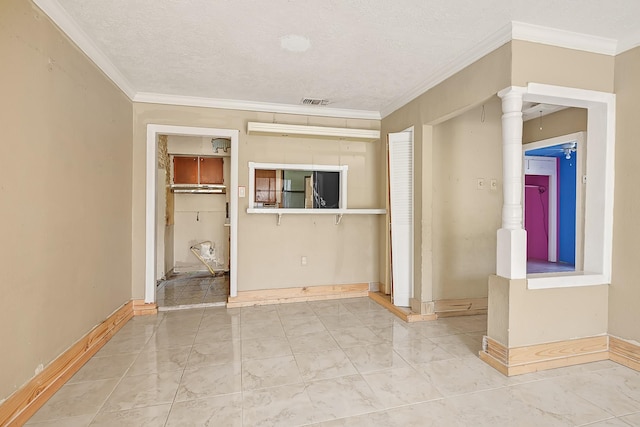empty room featuring ornamental molding, baseboards, marble finish floors, and a textured ceiling