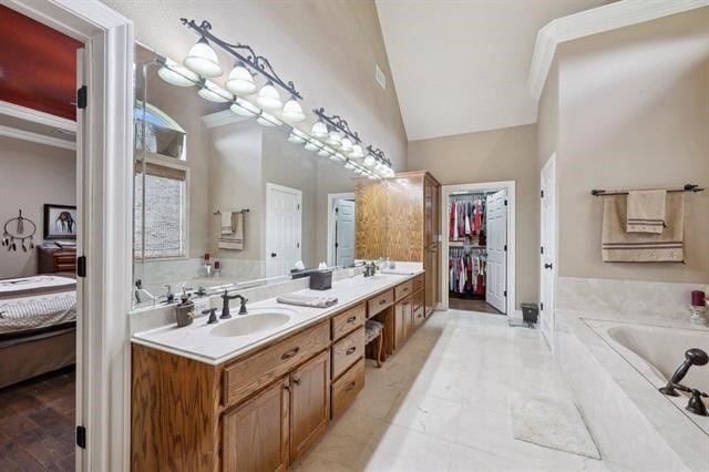 2014 Fish Lake Rd, Kountze, TX 77625 - full bathroom featuring connected bathroom, double vanity, a bath, and high vaulted ceiling
