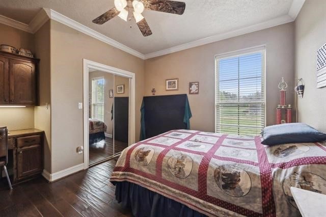 2014 Fish Lake Rd, Kountze, TX 77625 - bedroom with dark wood finished floors, baseboards, ornamental molding, and a ceiling fan